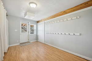 Entrance foyer featuring light wood-type flooring and a textured ceiling