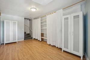 Interior space with light hardwood / wood-style flooring and a textured ceiling