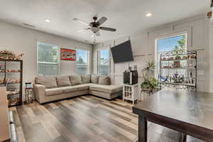 Living room featuring plenty of natural light, hardwood / wood-style floors, and ceiling fan