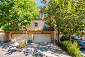 Townhome / multi-family property with a garage and central AC