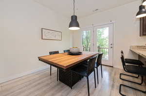 Dining area with light wood-type flooring