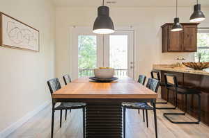 Dining room featuring a healthy amount of sunlight and light hardwood / wood-style floors