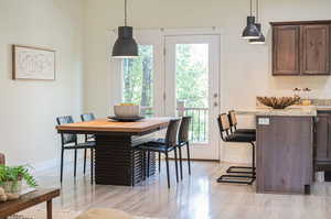 Dining room featuring light hardwood / wood-style flooring and a healthy amount of sunlight