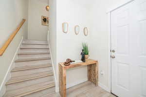 Stairway featuring light hardwood / wood-style floors