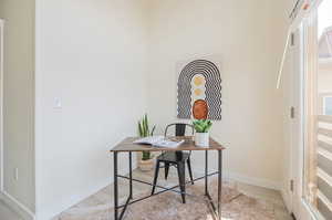 Office area with light hardwood / wood-style floors