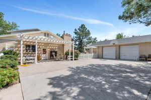 View of front facade with a pergola and a garage