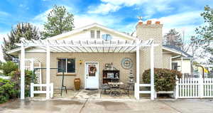 View of front of house featuring a patio and a pergola