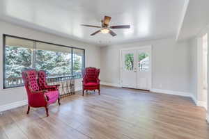 Living area with ceiling fan, french doors, and light hardwood / wood-style flooring