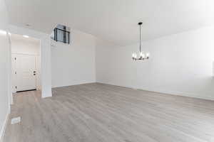 Interior space featuring a chandelier and light hardwood / wood-style flooring