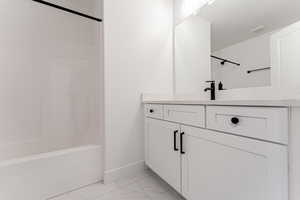 Bathroom featuring shower / bathtub combination and vanity