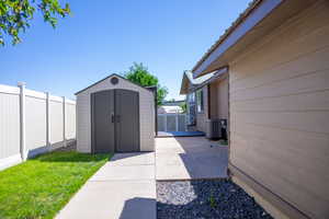 Exterior space featuring central air condition unit and a storage shed