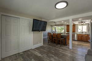 Kitchen featuring dark hardwood / wood-style floors, plenty of natural light, and a chandelier