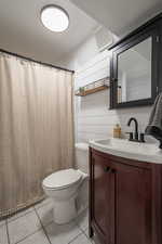 Bathroom with tile patterned floors, toilet, and vanity