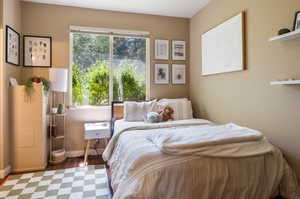 Bedroom with hardwood / wood-style flooring