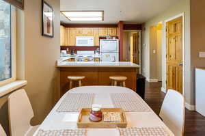 Dining space featuring dark wood-type flooring