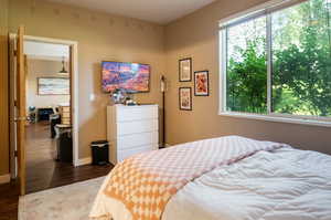 Bedroom with dark wood-type flooring