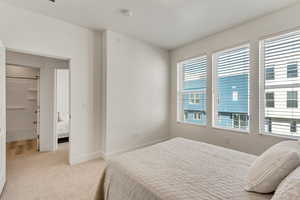 Bedroom featuring light colored carpet