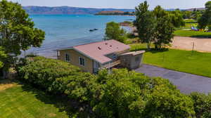 Birds eye view of property featuring a water and mountain view