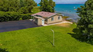 Birds eye view of property with a water view