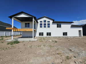 Back of house with a patio area