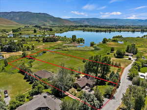 Birds eye view of property with a water and mountain view and a rural view