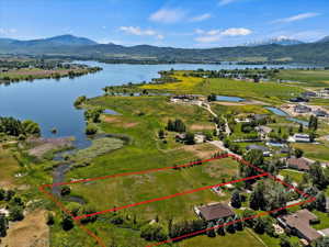 Birds eye view of property featuring a water and mountain view