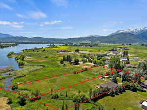 Birds eye view of property featuring a water and mountain view