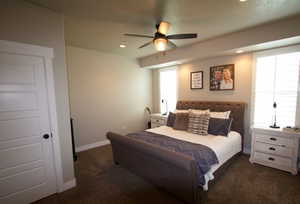 Bedroom featuring baseboards, ceiling fan, dark colored carpet, and recessed lighting