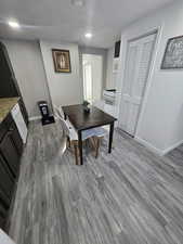 Dining area with dark wood-type flooring