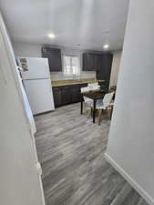 Kitchen with sink, white fridge, and light wood-type flooring