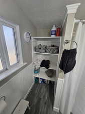 Spacious closet featuring dark wood-type flooring