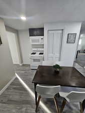 Dining space with dark hardwood / wood-style floors and a textured ceiling