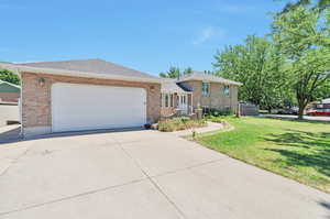 View of front of property with a garage and a front yard