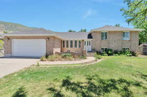 Tri-level home with a garage and a front yard