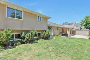 Rear view of property featuring a patio and a yard