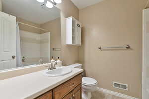 Bathroom with tile patterned floors, toilet, and vanity