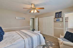 Bedroom with carpet flooring, a closet, and ceiling fan