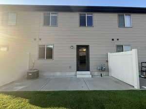 Rear view of property featuring a patio and central AC