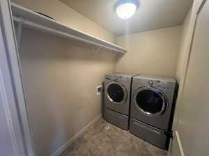 Laundry area featuring separate washer and dryer and tile patterned floors