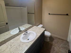 Full bathroom featuring vanity, toilet, tile patterned flooring, and  shower combination