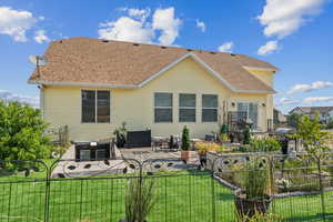 Rear view of property featuring a patio and a yard