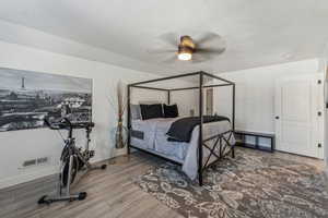 Bedroom with hardwood / wood-style flooring and ceiling fan