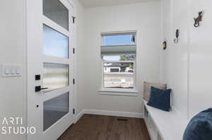 Doorway to outside with dark hardwood / wood-style floors