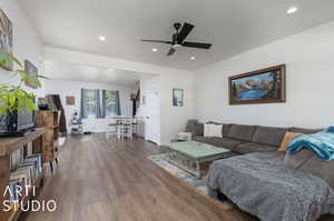 Living room with ceiling fan and hardwood / wood-style floors