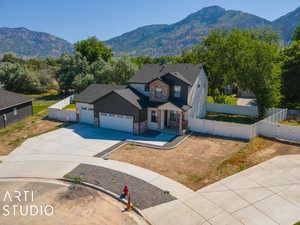 View of front of home with a garage and a mountain view