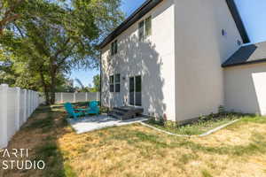 Rear view of property with a yard