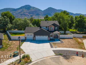 View of front facade featuring a mountain view, a patio, and a garage