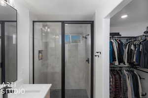 Bathroom with a shower with door and vanity