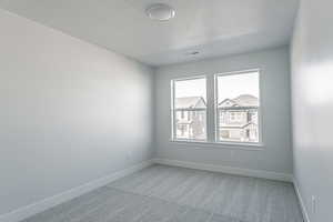 Unfurnished room with a textured ceiling and carpet flooring