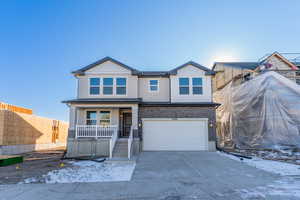 View of front of house with a garage and covered porch